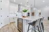 Quartz island with built in wine refrigerator, matte black hardware, and counter seating. A true centerpiece for hosting.