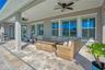 Covered lanai lounge with ceiling fan, perfect for relaxing year round in Central Florida.
