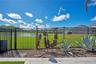 Fenced backyard opening to a water and conservation view behind the home.