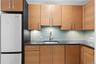 Kitchen with freestanding refrigerator, a sink, and backsplash