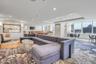 Living room featuring recessed lighting, baseboards, and a raised ceiling