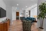 Living room with crown molding, light wood finished floors, recessed lighting, visible vents, and baseboards