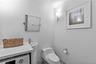 Bathroom with washer / dryer and toilet