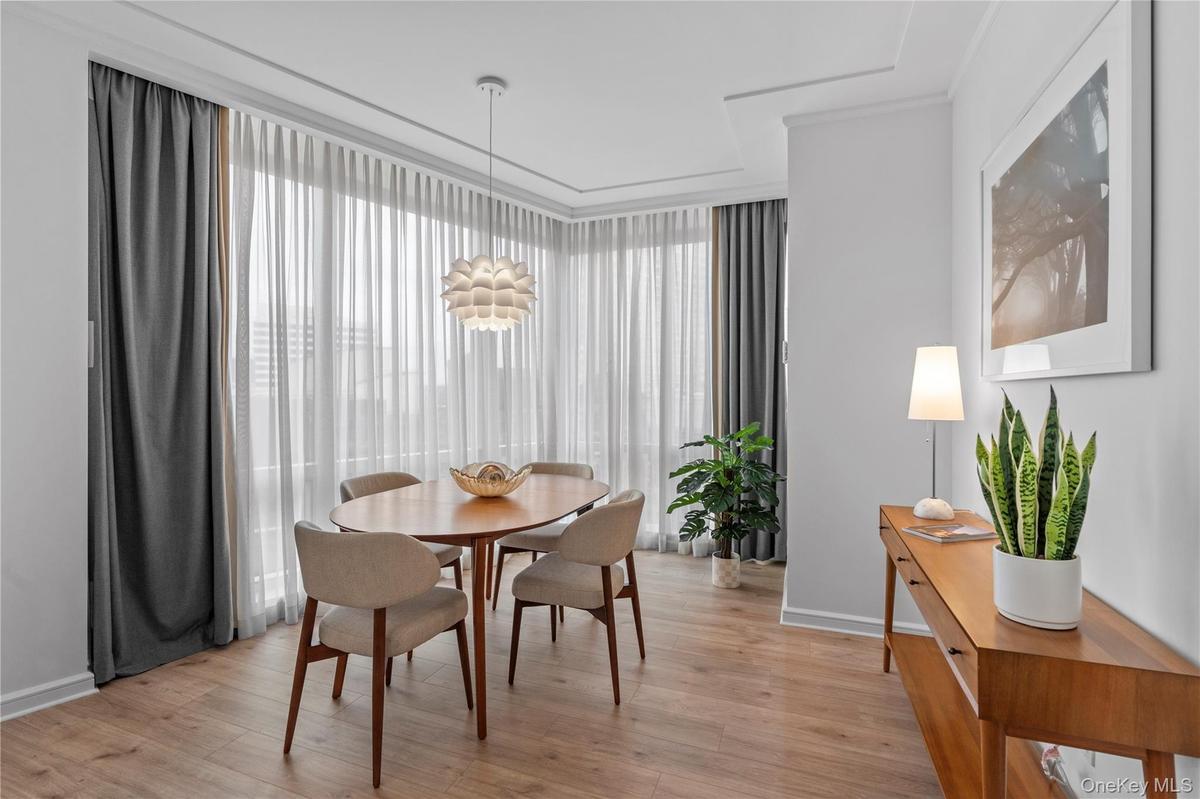 Dining space with light wood finished floors and a wealth of natural light