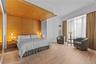 Bedroom with light wood-style floors, visible vents, and baseboards