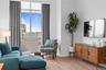 Sitting room featuring light wood-style floors, plenty of natural light, and baseboards