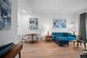 Living room featuring light wood finished floors, crown molding, baseboards, and recessed lighting