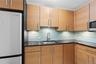 Kitchen featuring appliances with stainless steel finishes, a sink, and tasteful backsplash