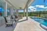 Extended covered lanai overlooking the pool and water and conservation view. Pre wired for surround sound.