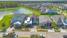 Aerial of the home along the pond with water and conservation views.