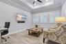 Flex room with tray ceiling and plantation shutters, ready for media, work, or guests.
