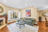 Formal living area featuring a wood-burning fireplace with an optional insert.
