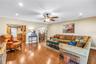 Spacious bonus family room (17x18) designed for effortless entertaining, featuring hurricane-rated sliders that offer seamless access to the screened 