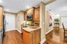 The kitchen features an efficient workspace equipped with a range, a convection microwave, and a preparation sink with an integrated butcher block cou