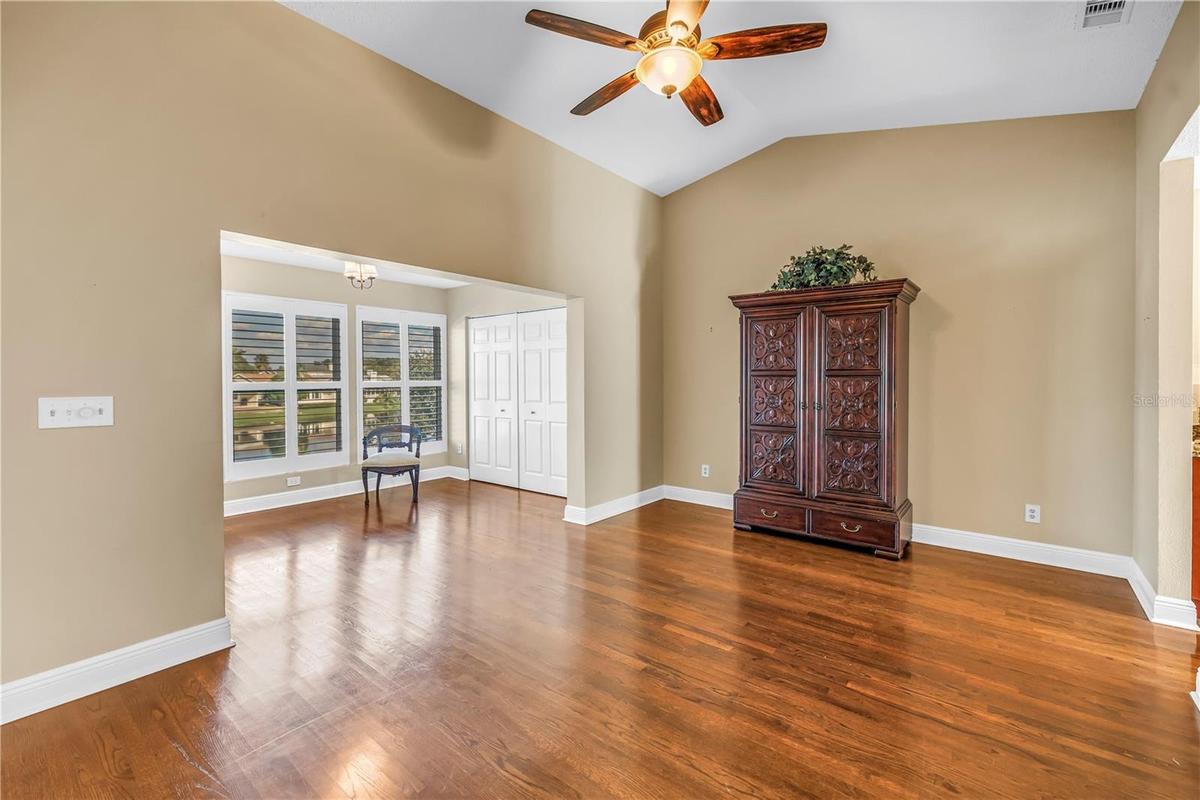 Spacious primary bedroom featuring vaulted ceilings and an elegantly enclosed porch with two additional closets. This room offers magnificent lake vie