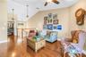 The upstairs bonus space features an open, vaulted ceiling, accessible via a custom-crafted staircase.