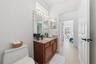 POOL BATH WITH 4TH BEDROOM IN THE BACKGROUND AND A DOOR SEPARATING FROM THE FAMILY ROOM
