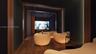 Dedicated media room featuring wood-finish flooring, vertical slat wall paneling, a recessed screen area, and a ceiling with integrated point-light fi