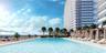 Resort-style pool deck featuring a swimming pool, sun terrace, and structured cabanas