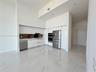 Kitchen featuring high-gloss white cabinetry, stainless steel appliances, built-in wall oven, metallic backsplash, and large-format porcelain tile flo