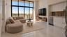 Floor-to-ceiling windows, polished stone-finish flooring, linear kitchen cabinetry with integrated stainless steel appliances, and a wall-mounted wood