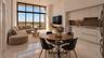 Floor-to-ceiling windows, high-gloss tile flooring, flat-panel cabinetry, and a built-in floating media console