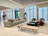 Expansive common area featuring floor-to-ceiling windows, polished stone tile flooring, recessed ceiling lighting, and layered tray ceiling detail