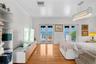 Wood-finish flooring, dual French doors, crystal-accented chandelier, and water backdrop