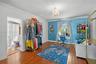 Hardwood flooring, crown molding, arched wall niches, and a multi-arm crystal chandelier