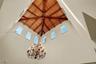 Vaulted ceiling with exposed wood-plank beams, clerestory windows, and a multi-tiered metal chandelier