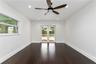 Wood-finish flooring, recessed lighting, dark-toned ceiling fan, and glass-paneled French doors