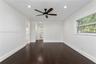 Interior space featuring dark wood-finish flooring, neutral wall paint, recessed lighting, and a ceiling fan