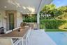 Covered patio featuring an outdoor kitchen with stainless steel appliances, stone-textured wall finish, recessed ceiling lighting, and tile flooring b