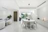 Open-concept interior featuring large-format polished stone flooring, recessed LED lighting, built-in cabinetry with a stone countertop, a modern pend