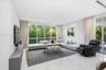 Floor-to-ceiling windows, polished stone flooring, recessed ceiling lighting, and floor-to-ceiling glass sliding doors