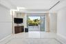 Interior space featuring polished stone flooring, recessed ceiling lighting, a linear HVAC diffuser, and expansive multi-panel sliding glass doors ope