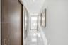 Hallway featuring polished tile flooring, recessed ceiling lighting, and wood-finish doors with integrated hardware