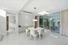 Polished stone-finish flooring, built-in wall cabinetry, recessed ceiling lighting, a modern pendant light fixture, and floor-to-ceiling sliding glass
