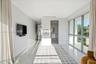 Expansive room featuring floor-to-ceiling windows, polished stone flooring, recessed ceiling lighting, and neutral wall tones