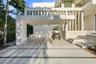 Modern exterior featuring a covered carport, recessed lighting, stone veneer accents, tiered concrete steps, and a segmented concrete driveway with st