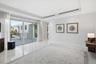 Interior space featuring polished stone flooring, recessed lighting, linear ceiling vents, and large-format sliding glass doors with access to an exte