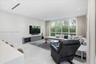 Living area featuring recessed ceiling lighting, linear air diffusers, large-format tile flooring, built-in cabinetry, and floor-to-ceiling windows