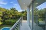 Balcony featuring metal horizontal-rail fencing, recessed ceiling lighting, and large-format sliding glass doors