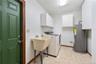 Laundry room just off kitchen with entrance from carport area.