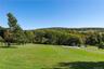 Expansive front yard with views of fields across the street