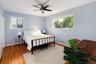 Tranquil primary bedroom faces back of house.