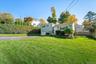 A gracious front lawn to greet the neighbors from.
