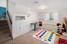 Lower level recreation space, door to large crawl/storage space.