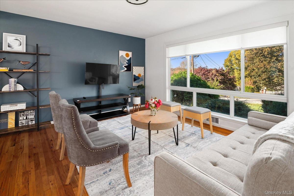 Large custom picture window overlooks the quiet street.