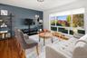 Large custom picture window overlooks the quiet street.